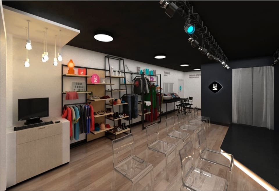 Interior of a fit-out unit in Sharjah Free Zone showing large-format porcelain and natural-stone tiling laid in a warm wood-plank pattern across the floor, with a dark charcoal ceiling, track and pendant lighting, black metal display shelving and a clean, level tiled surface.